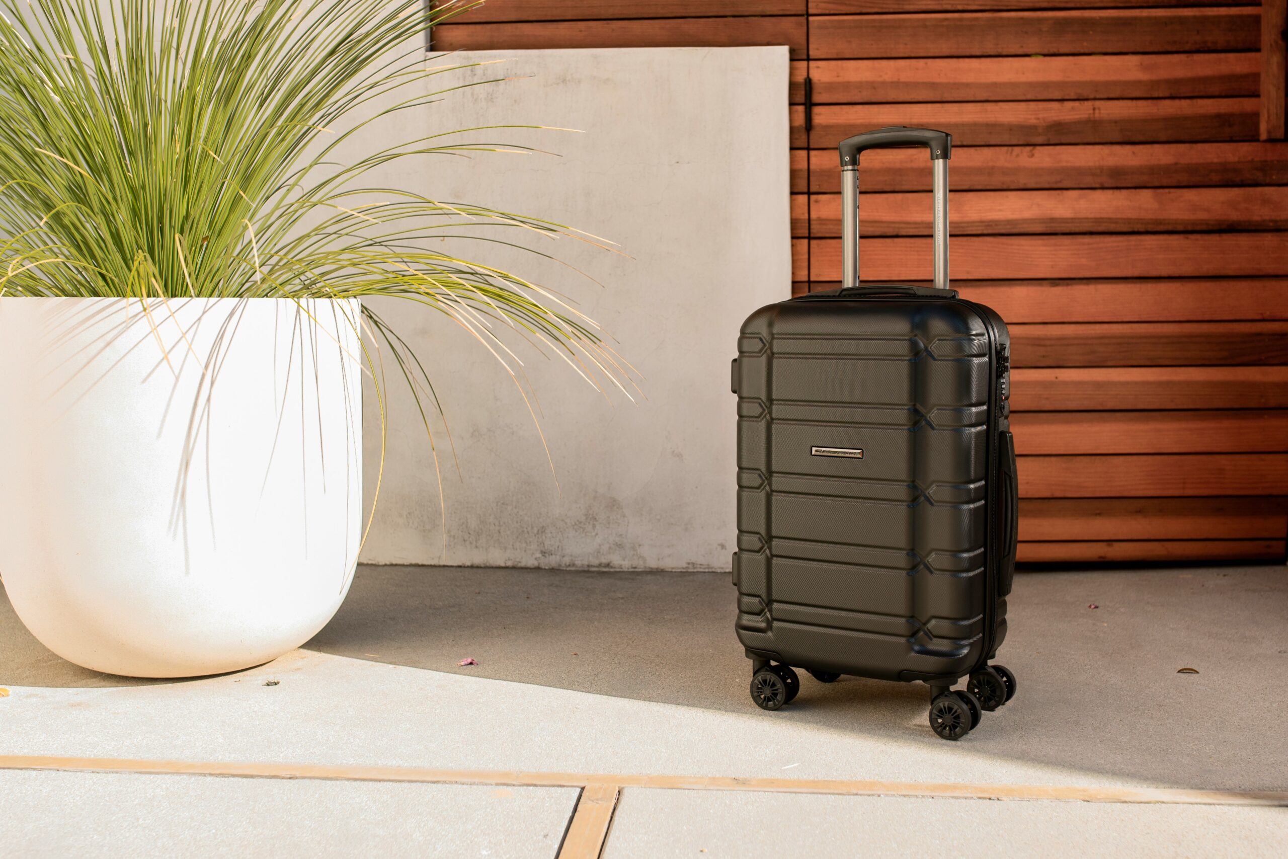Close-up of a modern ergonomic luggage handle with customizable engraving