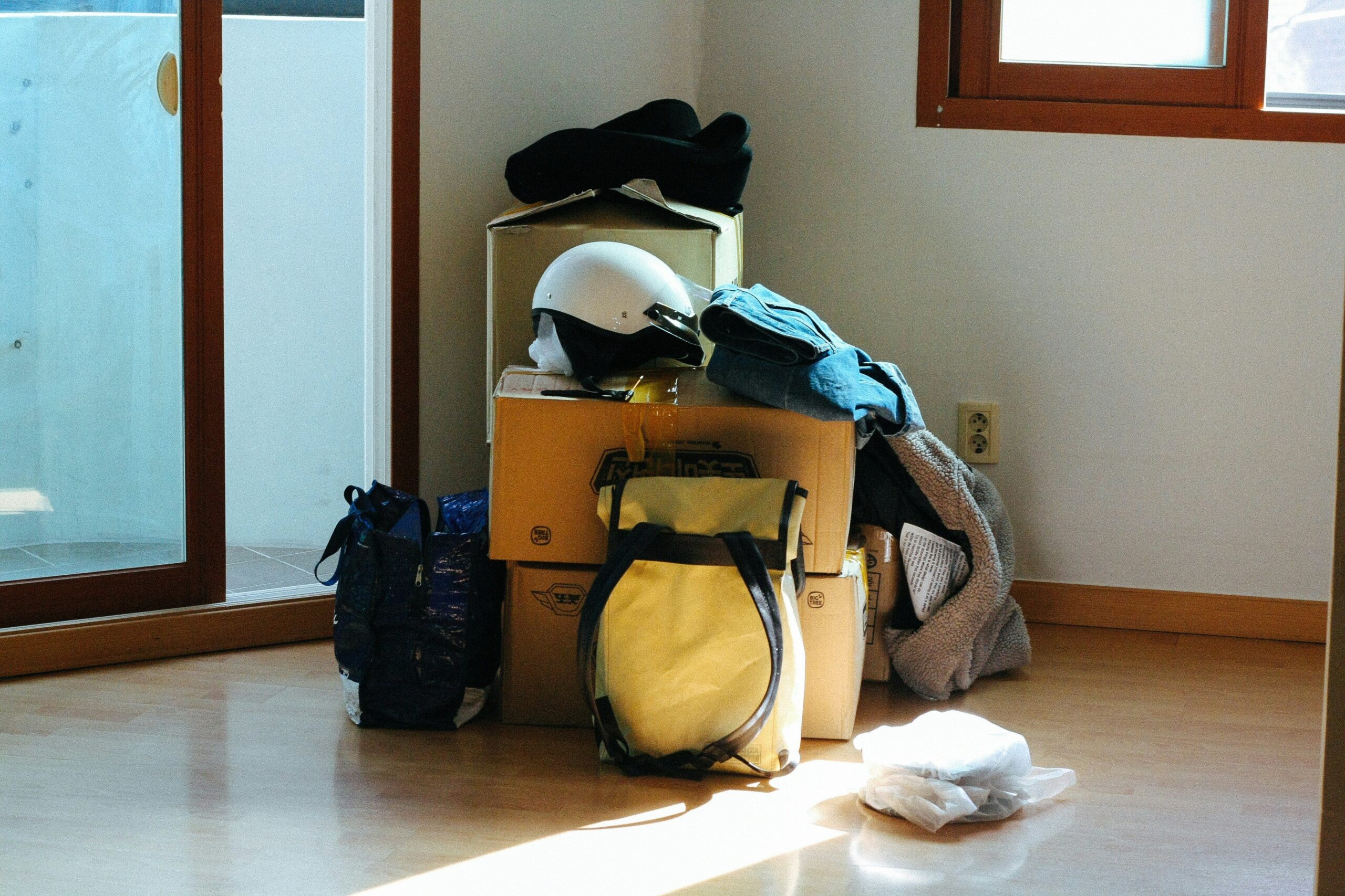 An influencer posing next to neatly organized luggage with modular packing cubes