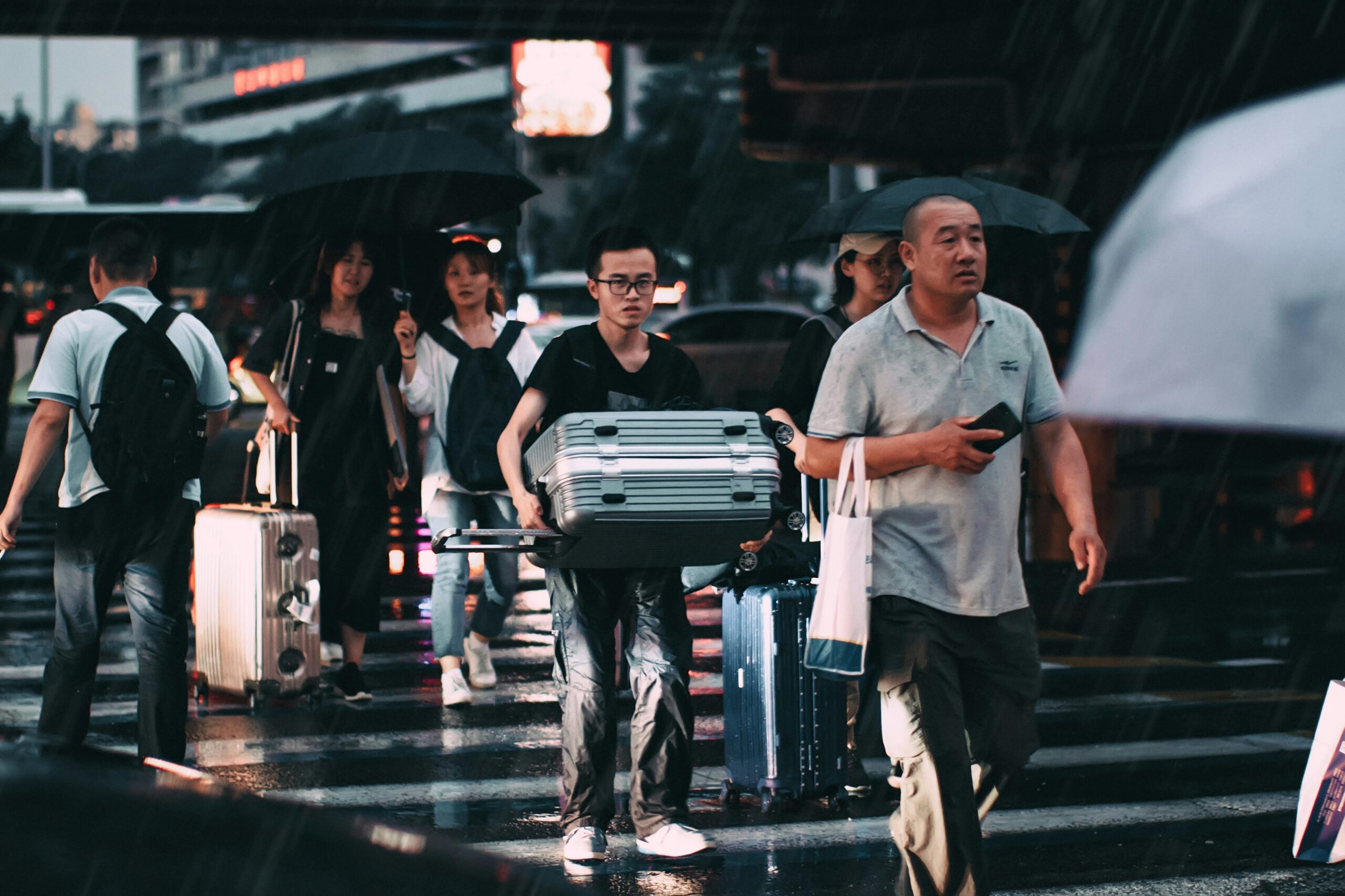 Influencer standing next to stylish designer luggage at airport