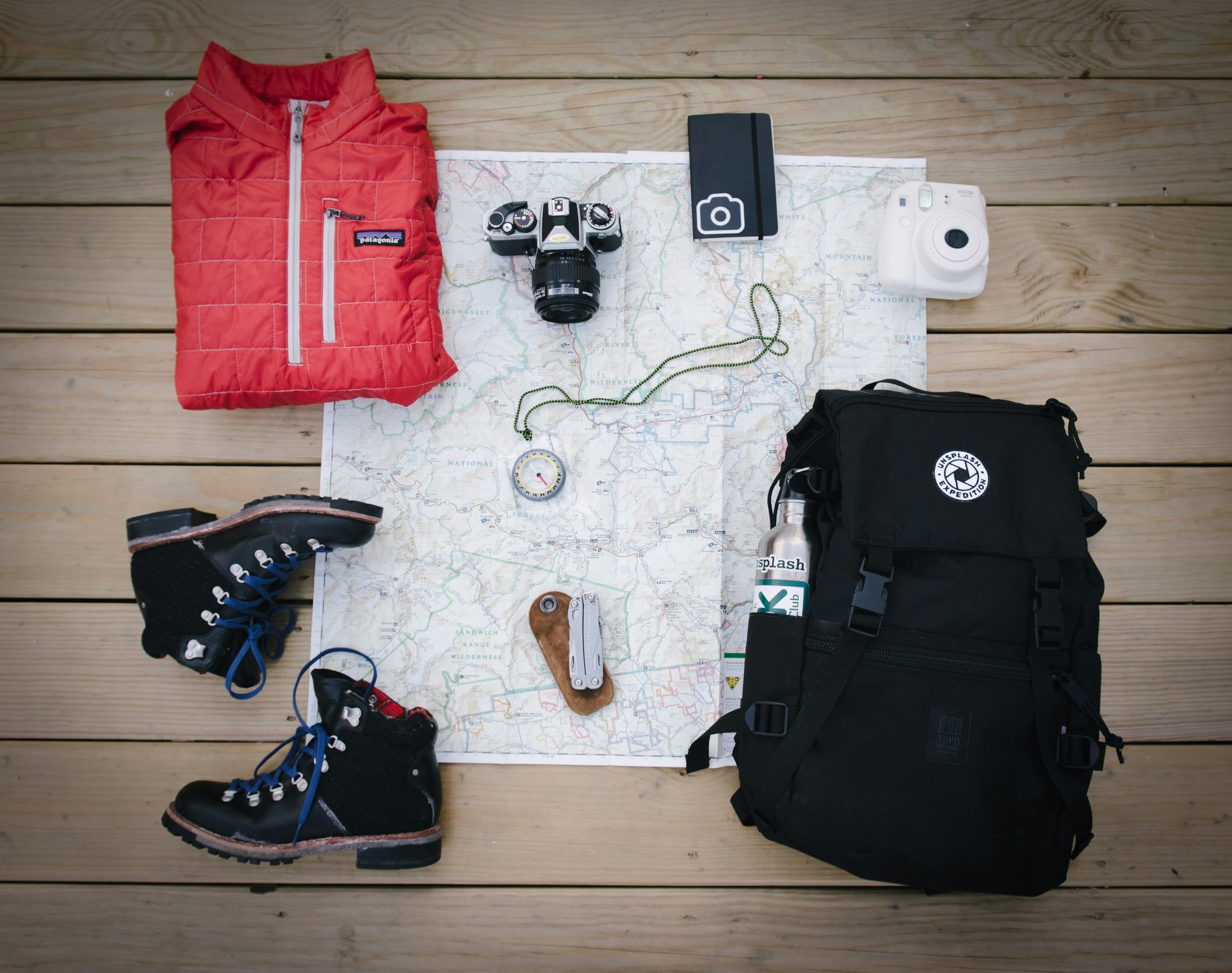 A professional creator packing her laptop, cameras, and accessories into durable luggage designed for influencers.