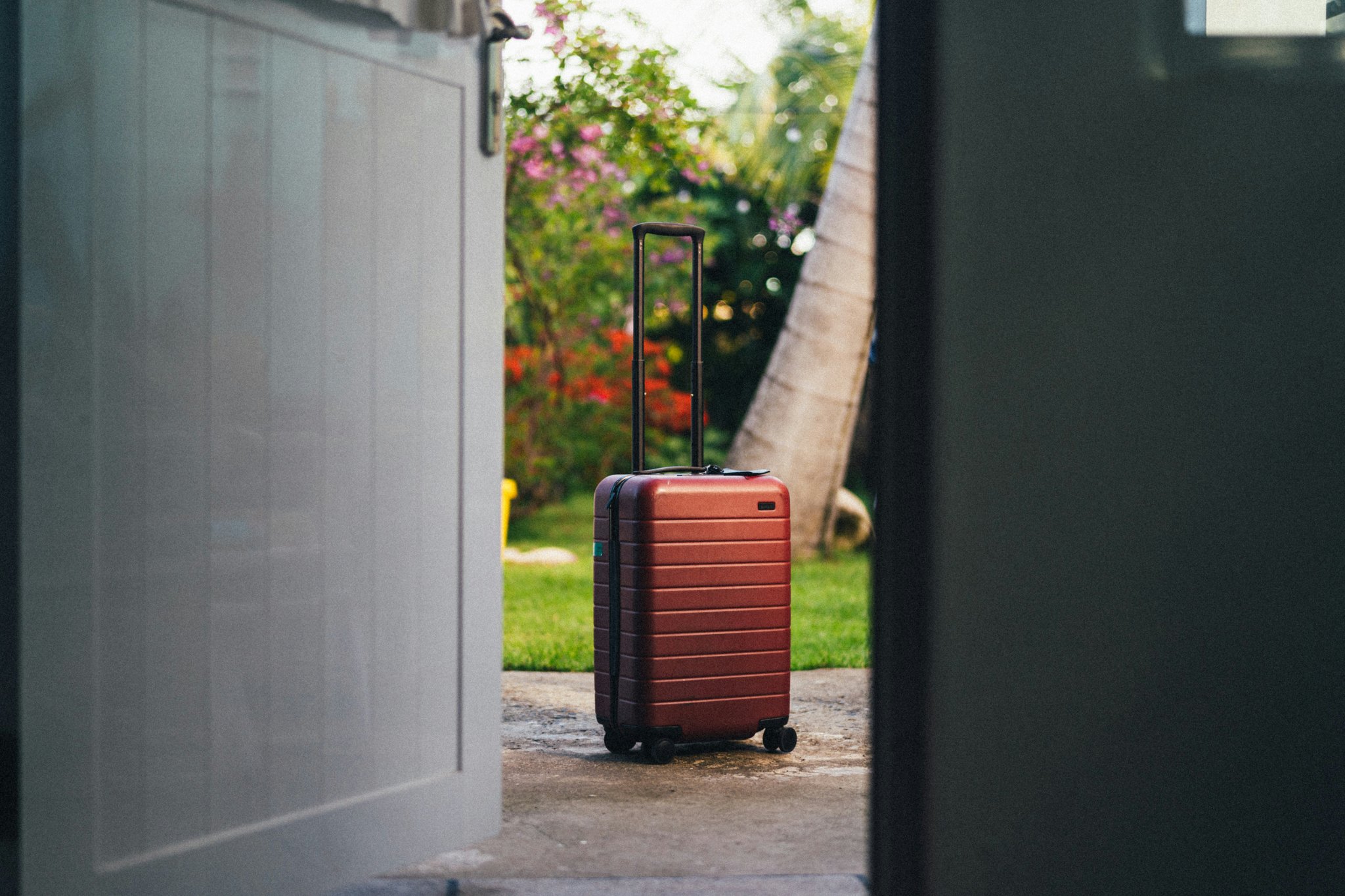 A stylish carry-on suitcase with mounted camera rig attached