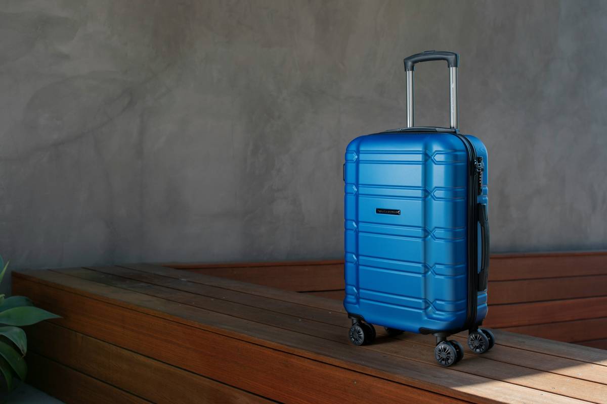 A stylish metallic rose-gold suitcase paired with matching travel pouches