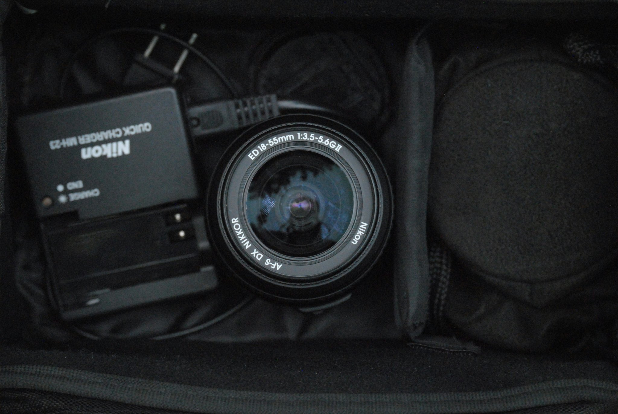 A close-up shot of a camera nestled securely in a compartmentalized luggage section.