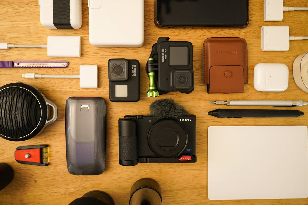 An overloaded tech organizer spilling gadgets