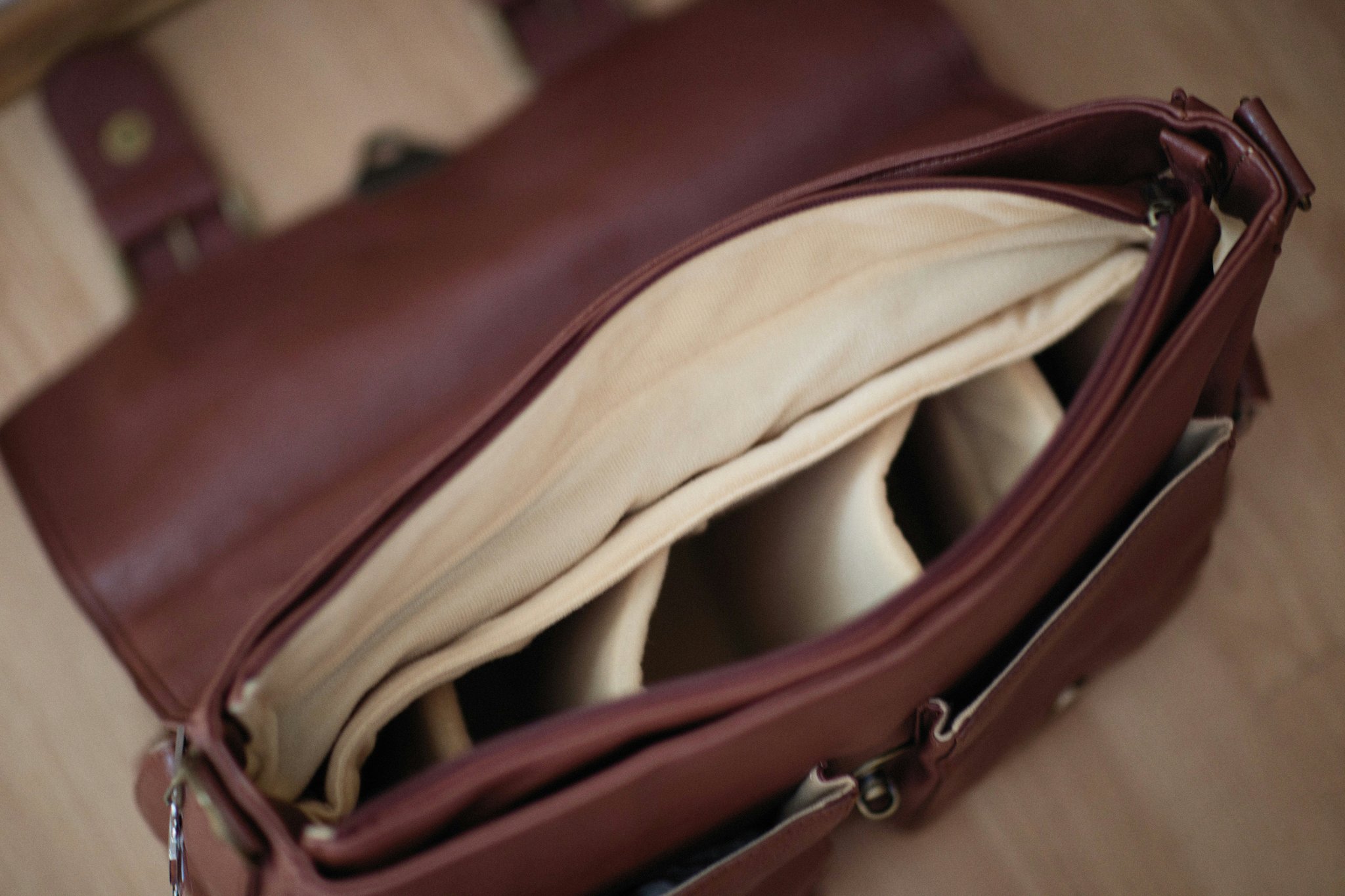 An influencer adjusting modular dividers within a camera-friendly luggage compartment.