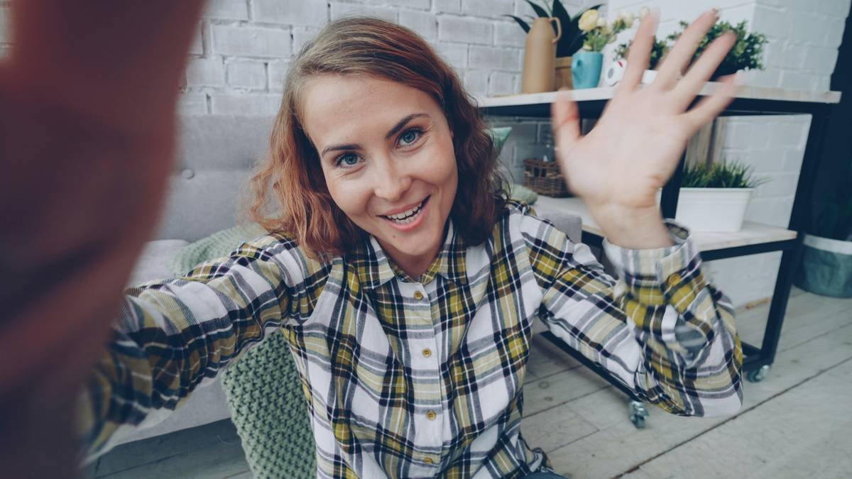 A person unboxing vibrant, colorful personalized luggage designed with floral patterns