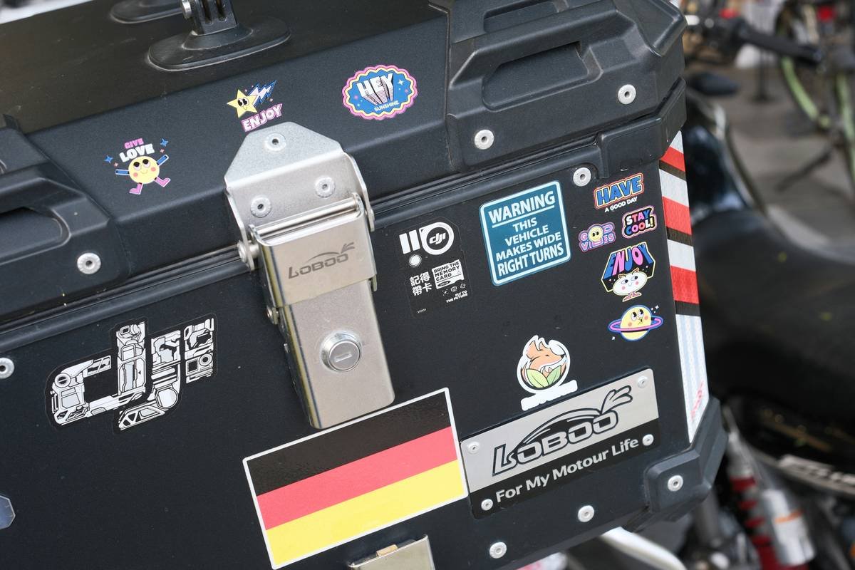 Close-up of designer selecting patterns for custom luggage