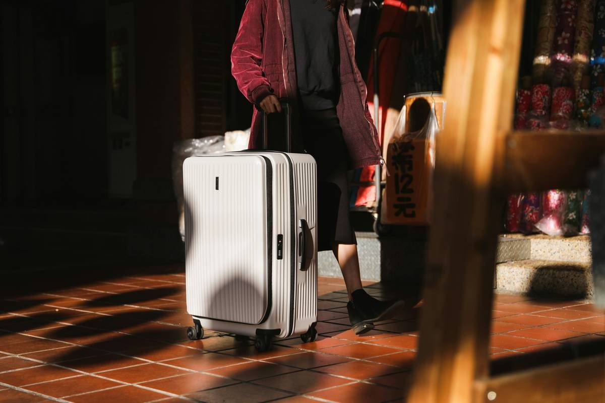 A sleek black hard-shell suitcase tagged as 'influencer favorite'
