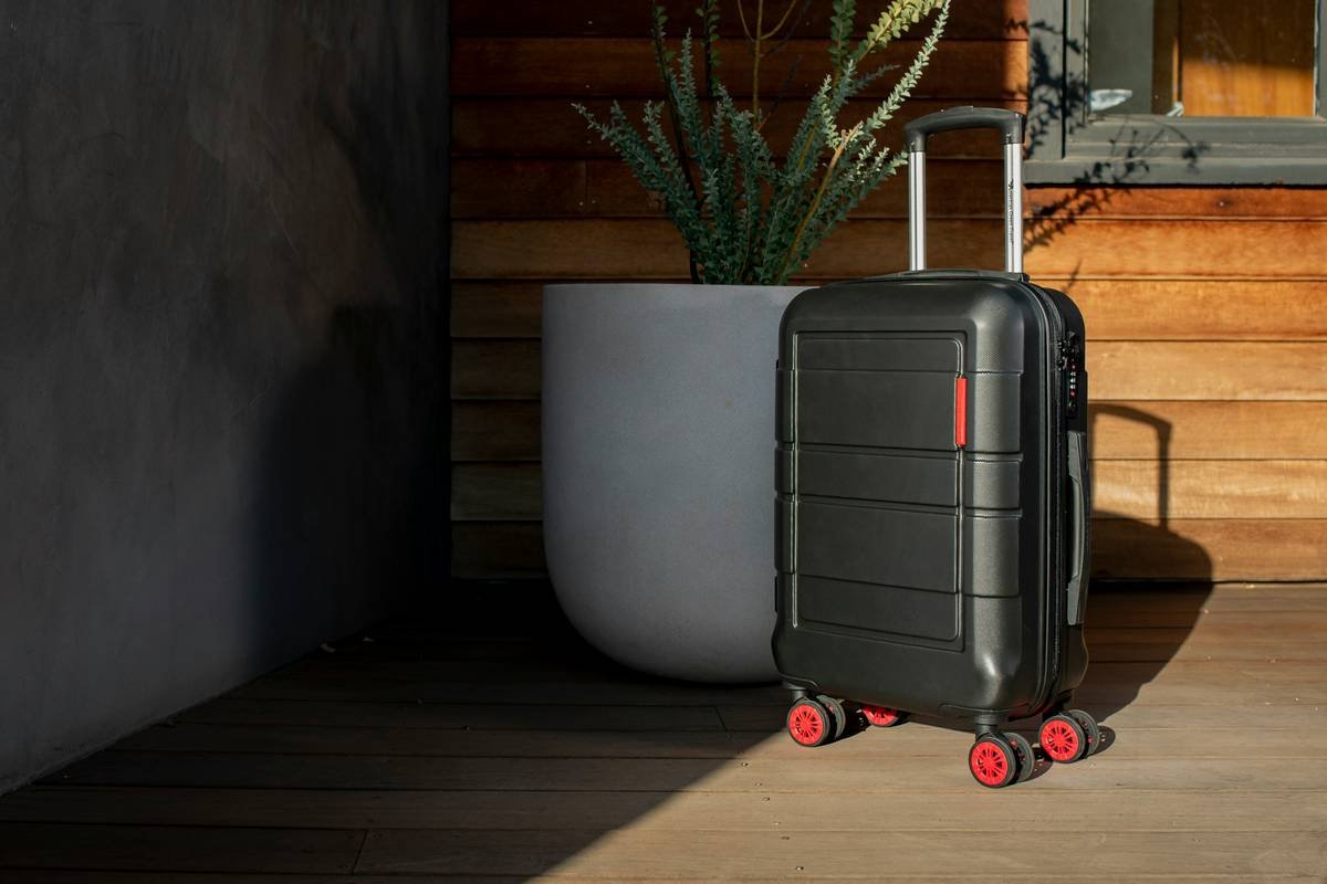A stylish beige roller suitcase designed for social media creators