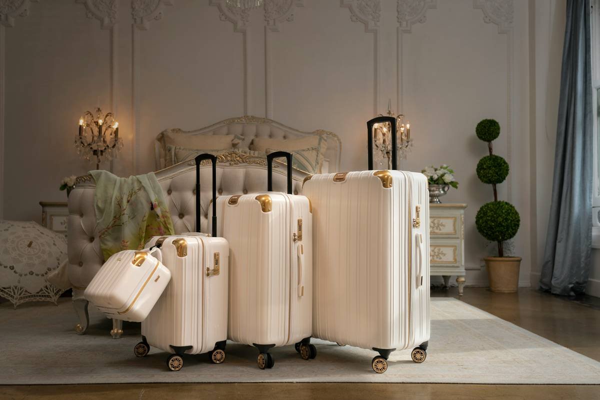 A sleek white suitcase styled against a boho-chic travel setup