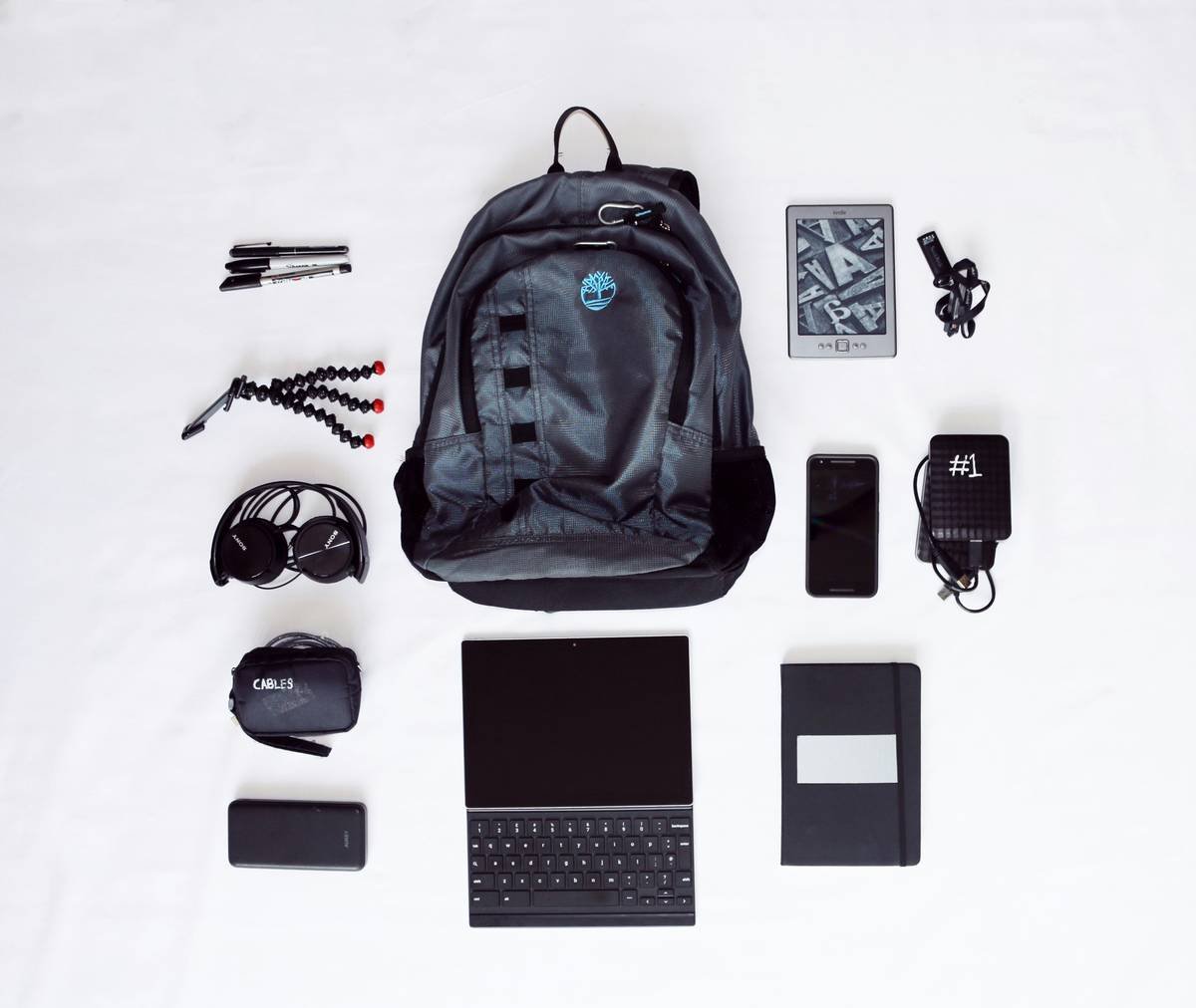 A sleek black suitcase filled with creative gear like laptops, tripods, and camera equipment.
